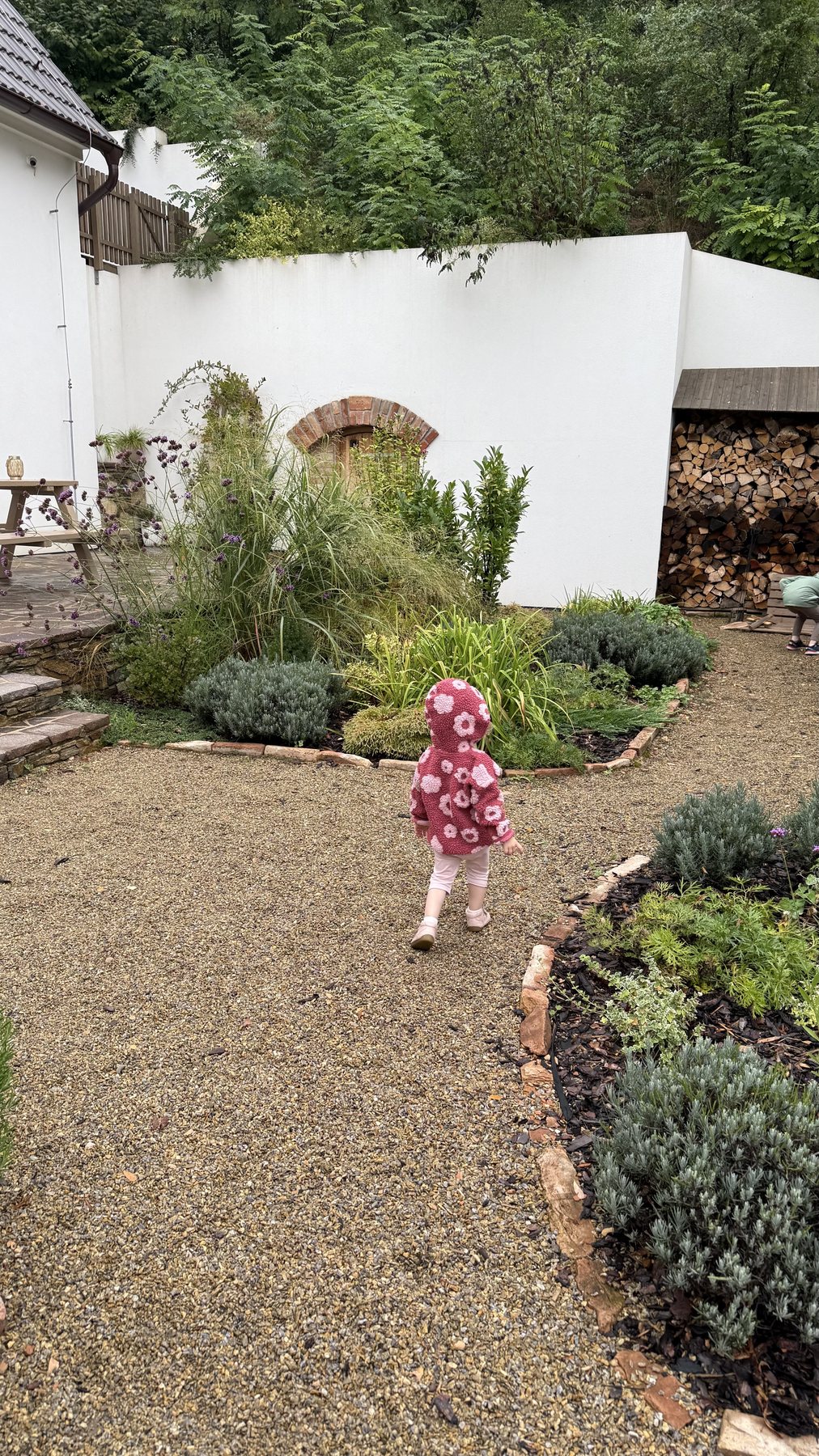 Child exploring the private garden behind the cottage
