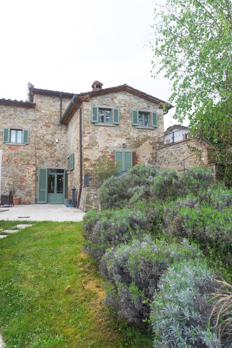 Stone farmhouse with lavender and olive trees in the garden